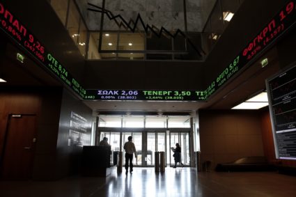People make their way at the entrance hall of the Athens Stock exchange