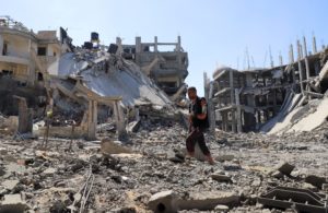 Palestinian man Jehad Al-Shagnobi, who was injured in an earlier Israeli strike on his house, walks with an external fixat...