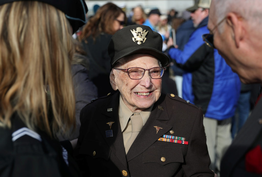 Elizabeth Lewis, a Vetaran who was an army nurse in 1943 and assigned to an army hospital ship, smiles after laying wreath...