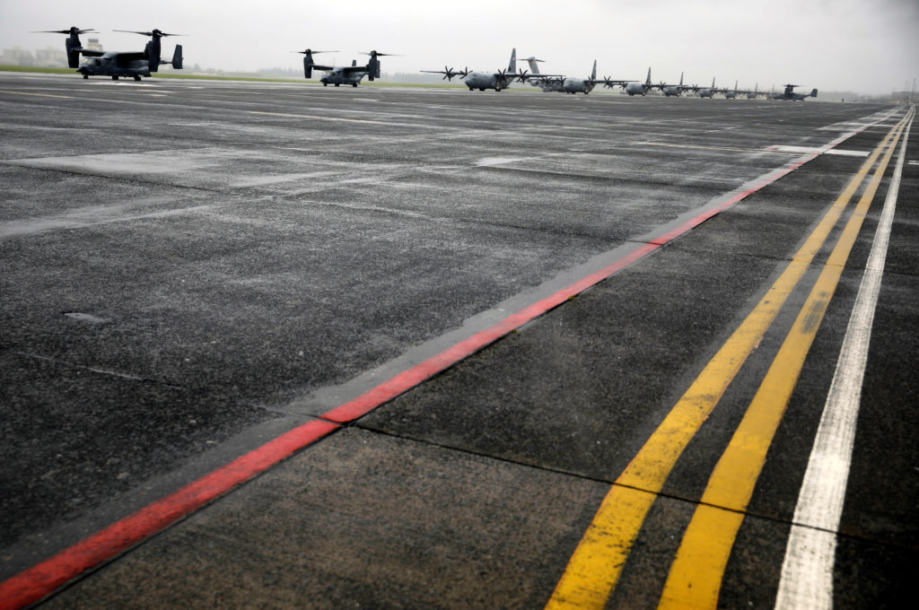 A Bell Boeing V-22 Osprey aircrafts and C-130 transport planes prepare to take off during a military drill amid the corona...