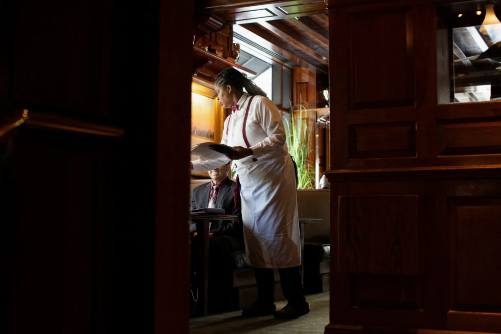 Waitress Mattie Wright serves guests at the Old Ebbitt Grill in Washington