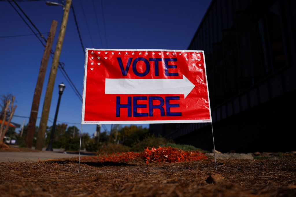 A sign sits outside of a polling location as the battleground state opened for early voting, in Atlanta