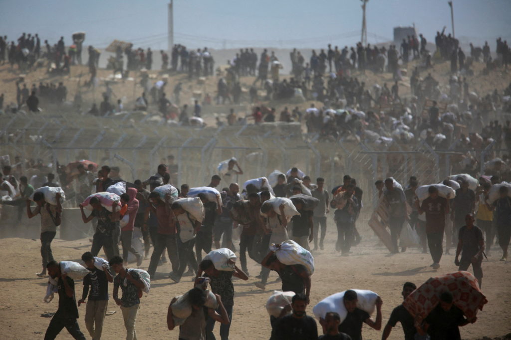 Palestinians seek aid supplies from the U.S.-backed Gaza Humanitarian Foundation (GHF), in the central Gaza Strip