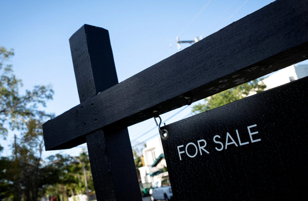FILE PHOTO: A "For Sale" sign stands at a house in Miami