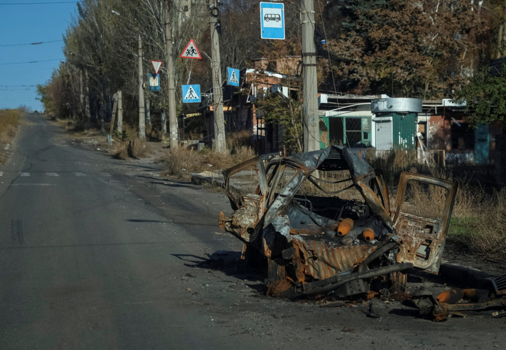 A destroyed car damaged by Russian military strike lies on a road in the frontline town of Kostiantynivka