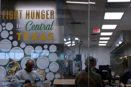 FILE PHOTO: Volunteers pack snack bags and meals for afterschool programs in the Central Texas Food Bank warehouse kitchen...