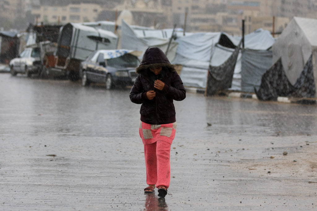 Palestinians shelter in tents during rain in Gaza City