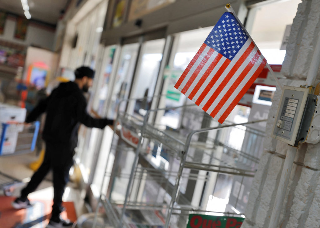 Supermarket employee guards against federal immigration authorities in North Carolina