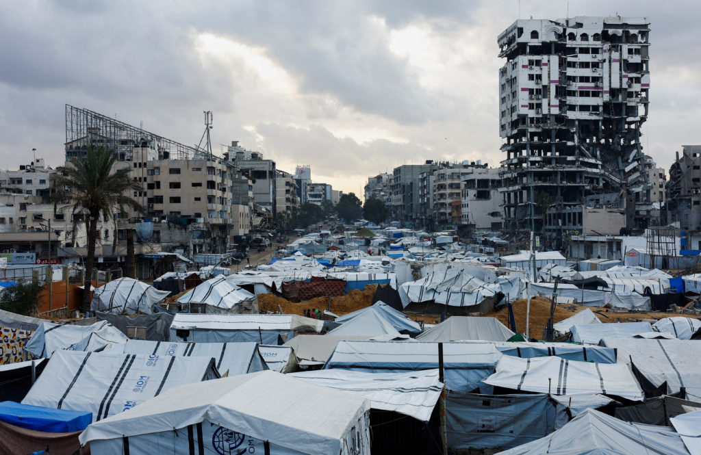 Palestinians shelter in tents on a rainy day in Gaza City