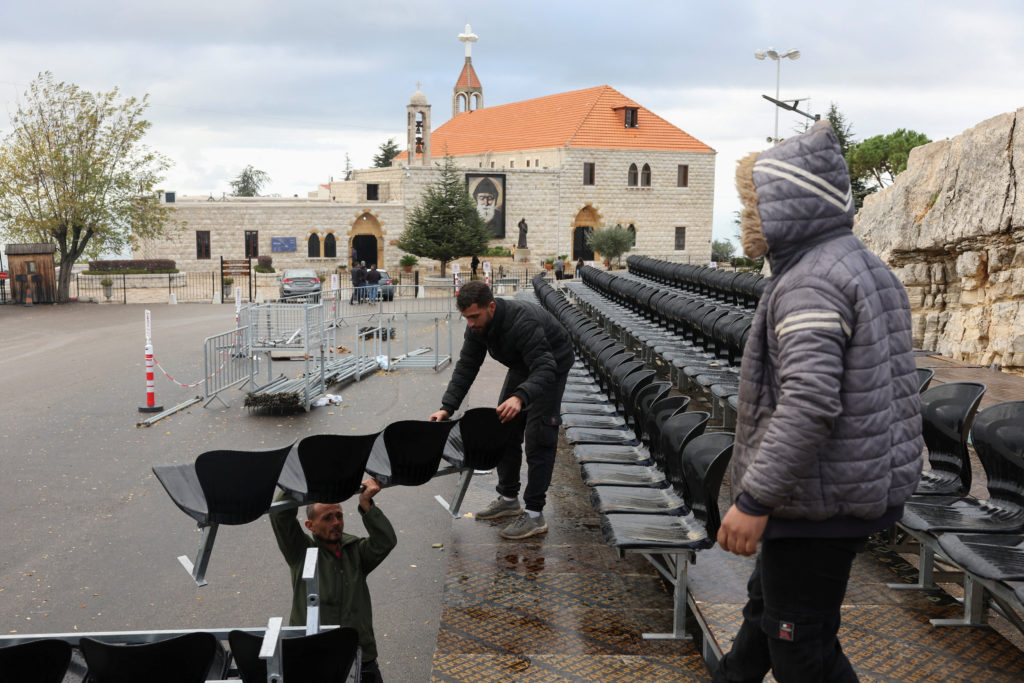 People plsce chairs during the preparations to welcome the Pope Leo XIV, ahead of his visit, at the Saint Maroun monastery...
