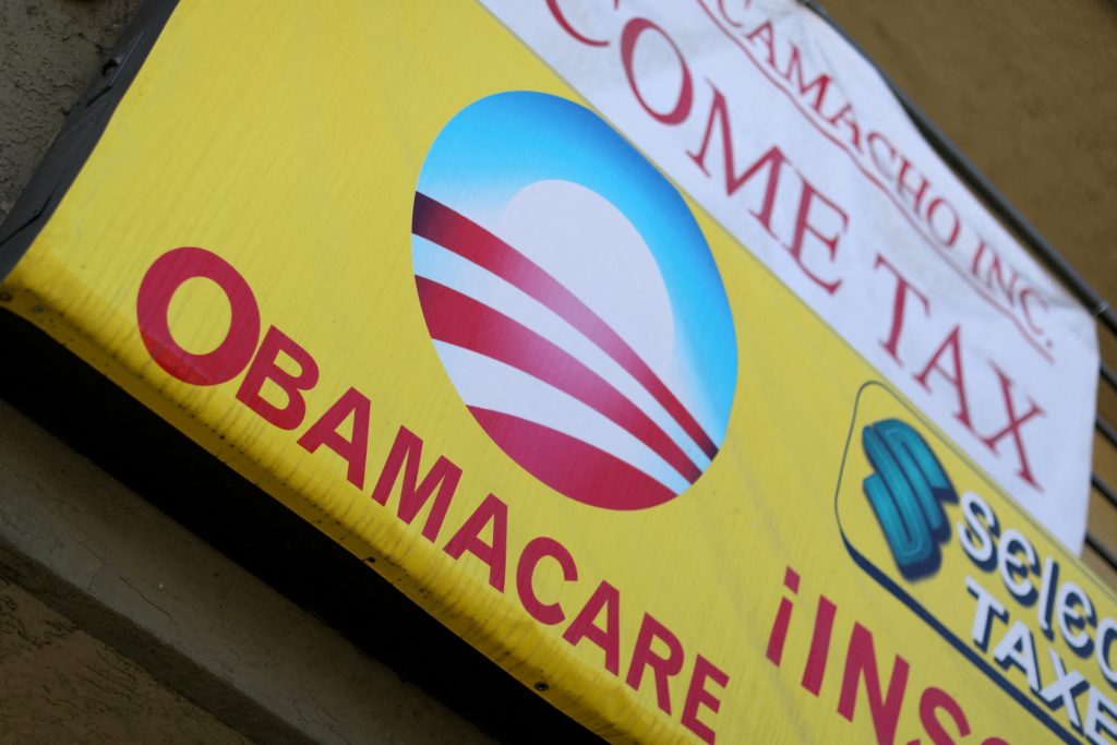FILE PHOTO: A sign on an insurance store advertises Obamacare in San Ysidro
