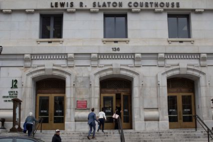 People prepare to enter Fulton County Courthouse in Atlanta, Georgia