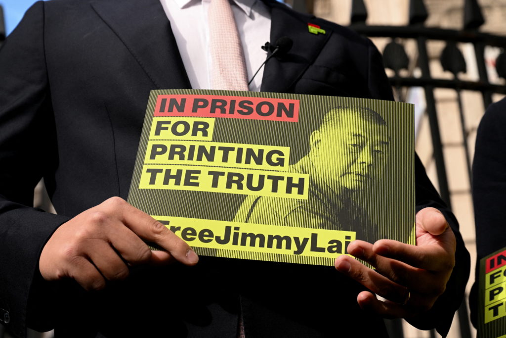Sebastien Lai, son of jailed media tycoon Jimmy Lai, holds a sign outside Downing Street, in London