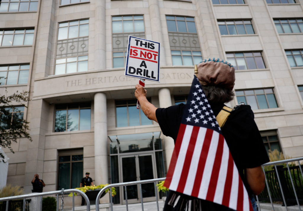 People protest outside the Heritage Foundation, in Washington
