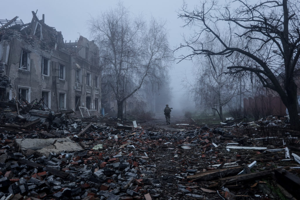 Ukrainian serviceman walks near apartment buildings damaged by Russian military strike in the frontline town of Kostiantyn...