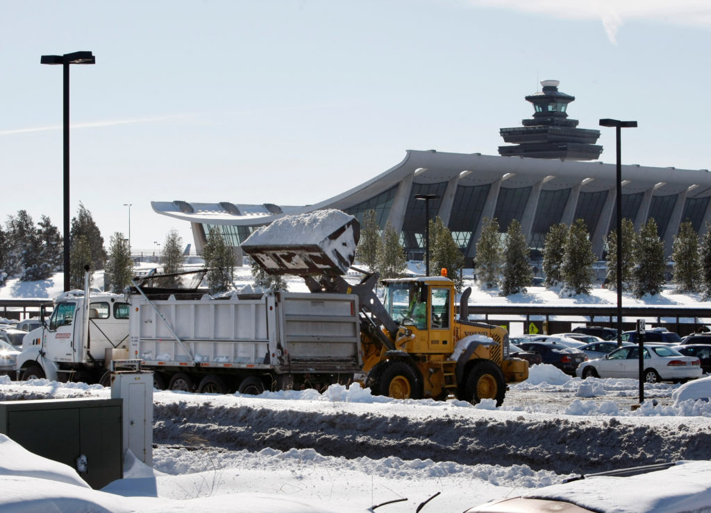 FILE PHOTO: A skip loader removes snow in the parking lot after a heavy snowstorm at Dulles International Airport outside ...