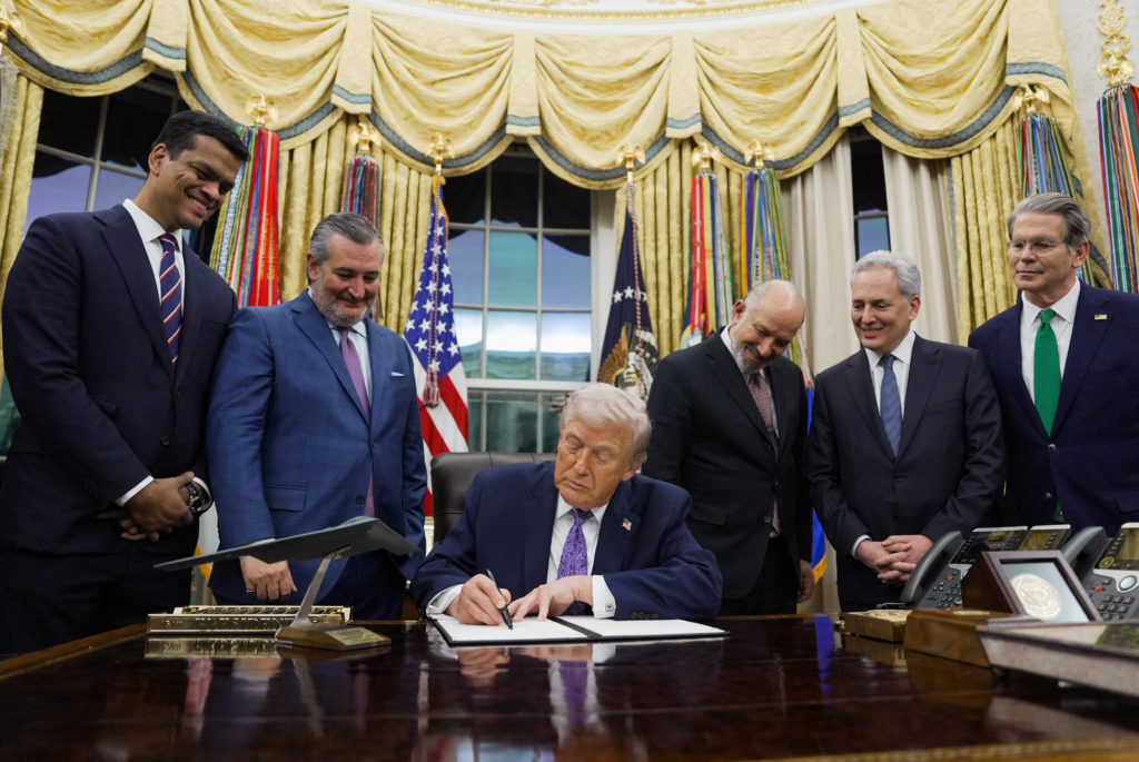 U.S. President Donald Trump signs an executive order in the Oval Office of the White House