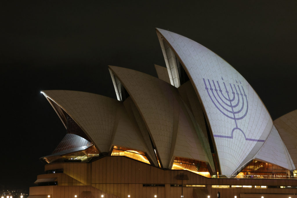 A menorah is projected onto the Sydney Opera House sails after a shooting during a Jewish holiday celebration at Bondi Bea...
