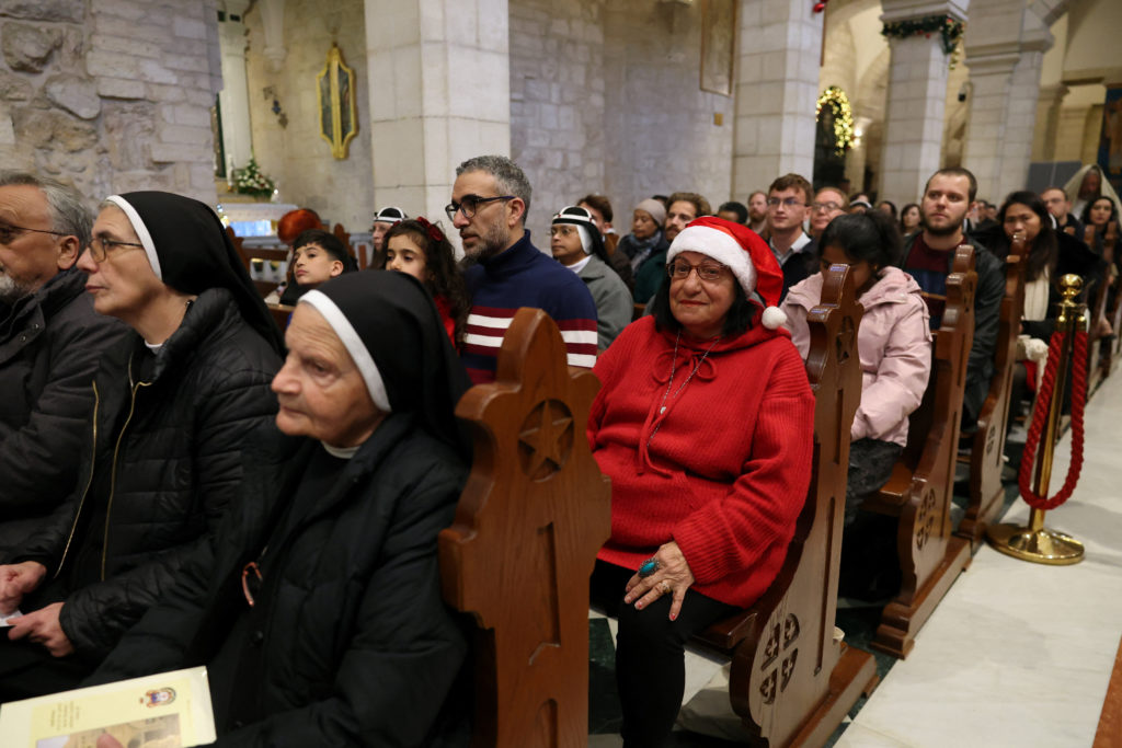 Worshipers pray inside the Church of the Nativity, in Bethlehem