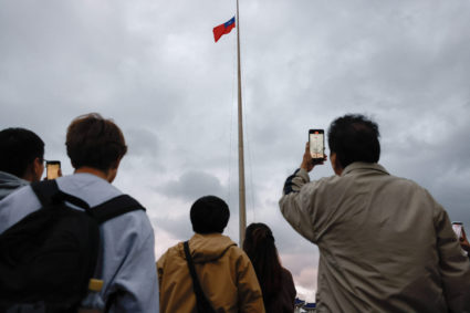 Taiwan's flag is lowered during a daily ceremony as China conducts "Justice Mission 2025" military drills around Taiwan, i...