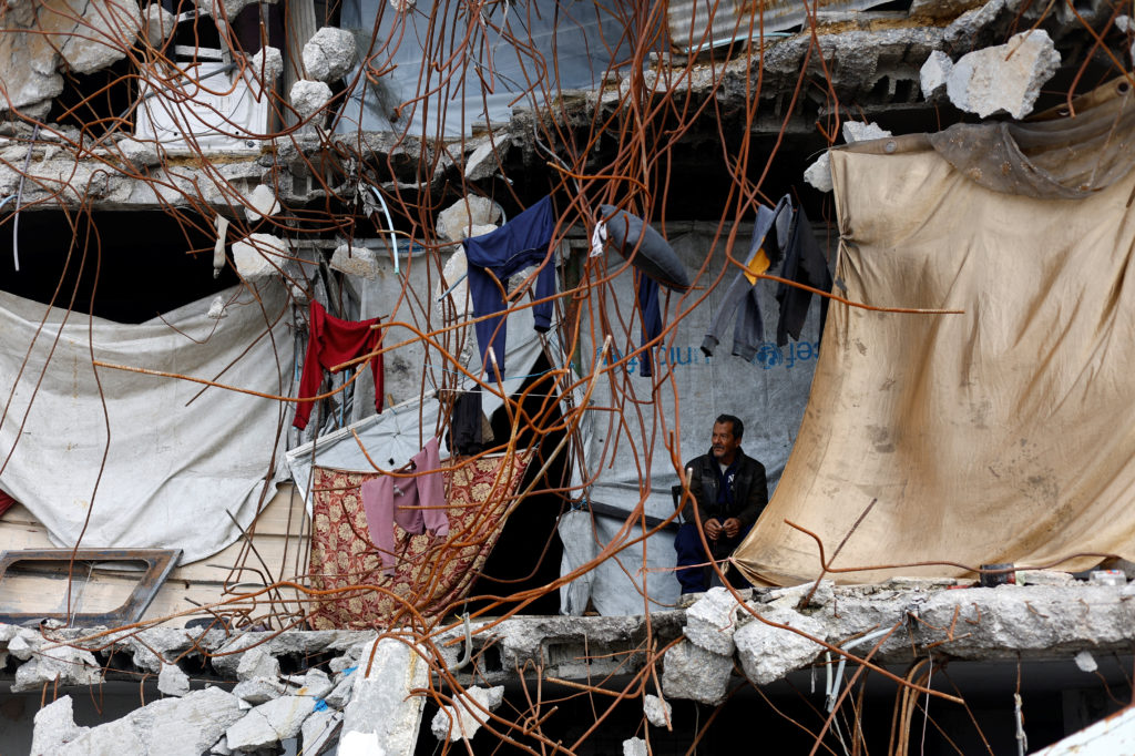 Palestinian man amid the rubble of a building destroyed during the war, on New Year's Eve in Jabalia