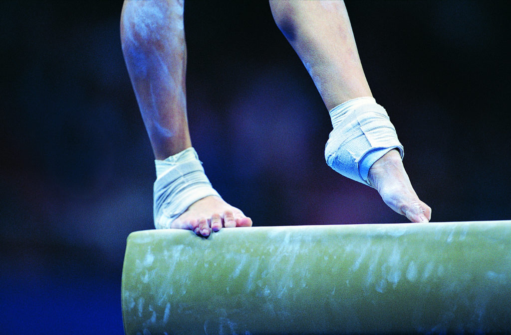Picture of female gymnast's wrapped feet on balance beam