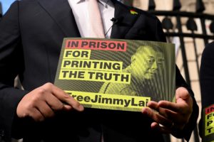 Sebastien Lai, son of jailed media tycoon Jimmy Lai, holds a sign outside Downing Street, in London