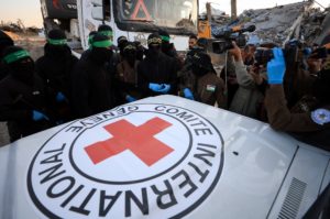 Red Cross members receive a body recovered by Palestinian Hamas and Islamic Jihad militants, in Beit Lahiya