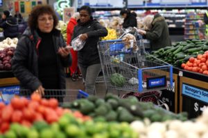 FILE PHOTO: Customers shop for groceries in Walmart Supercenter retail store in North Bergen, New Jersey