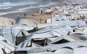 Flooded beach tent camp sheltering displaced Palestinians in Khan Younis