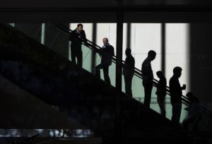 People ride the escalators in the JP Morgan &amp; Chase Co. building in New York