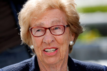 Auschwitz survivor Eva Schloss, stepsister of Holocaust diarist Anne Frank, listens to Chabad Rabbi Reuven Mintz at Newpor...