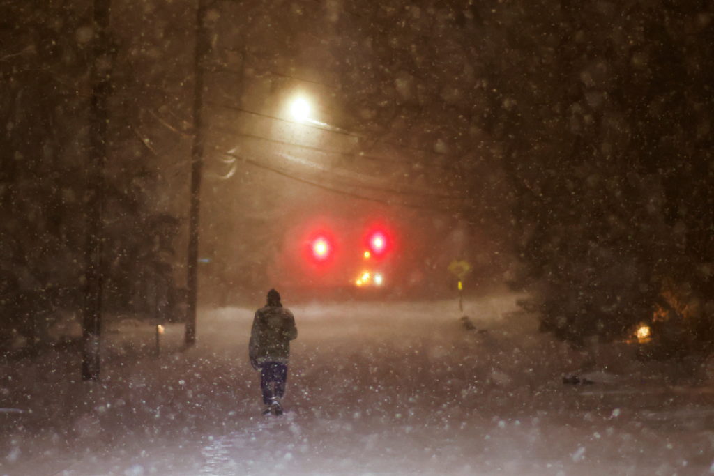 A man walks along an empty road during the pass of a polar vortex in Norwood, New Jersey