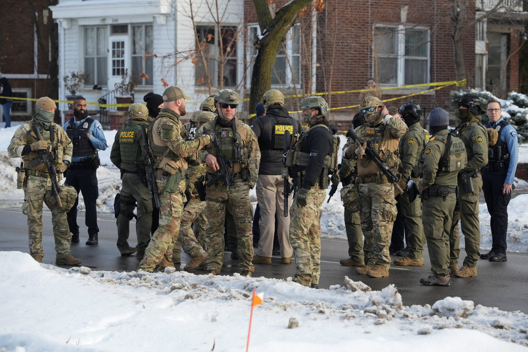 Members of U.S. Immigration and Customs Enforcement (ICE) gather at the scene where a driver was shot by a U.S. immigratio...