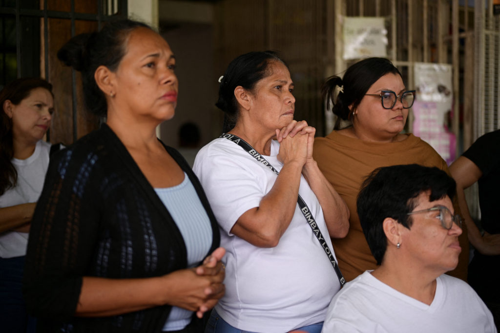 Family members of detainees wait outside the El Rodeo jail, in El Rodeo