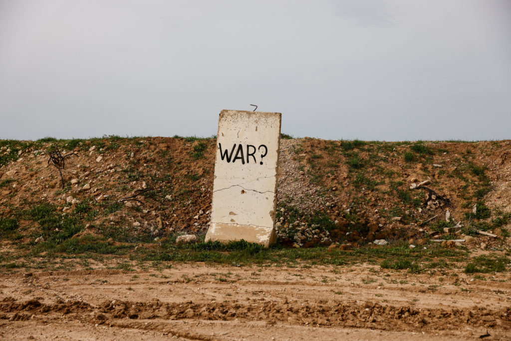 "War?" is written on a concrete block at the Israeli side of the Israel-Gaza border