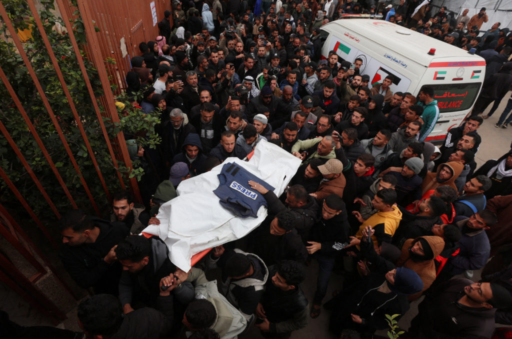 Mourners carry the body of one of the Palestinian journalists killed in an Israeli airstrike, in Khan Younis