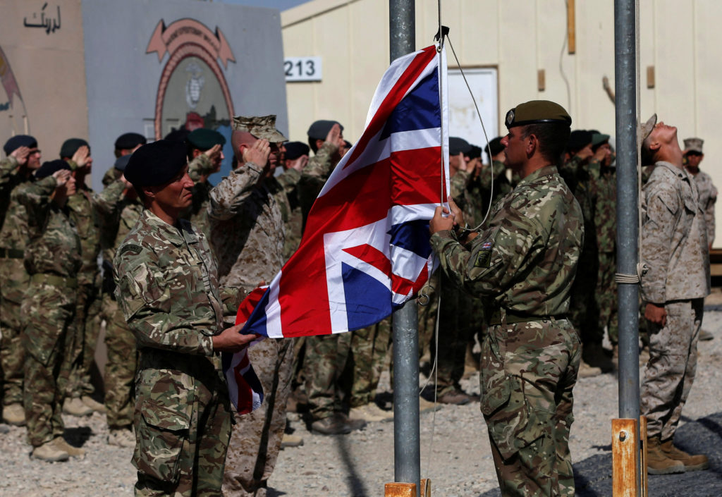FILE PHOTO: British troops lower the Union Flag during a ceremony marking the end of operations for U.S. Marines and Briti...