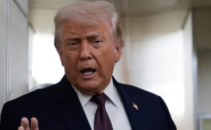 FILE PHOTO: U.S. President Donald Trump speaks to reporters aboard Air Force One
