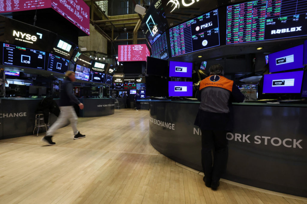 Traders work on the floor of the NYSE in New York