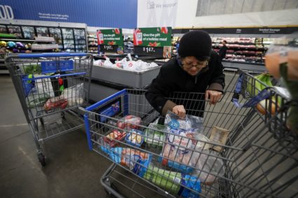FILE PHOTO: Customers shop for groceries in Walmart Supercenter retail store in North Bergen, New Jersey