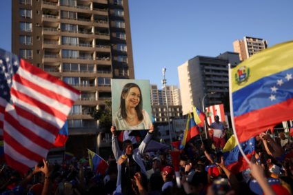 People celebrate after the U.S. struck Venezuela and captured its President Nicolas Maduro and his wife Cilia Flores, in S...