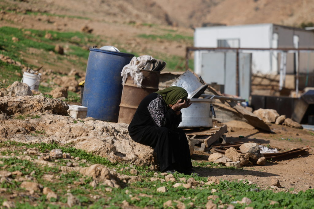 Members of a Palestinian Bedouin community leave Ein al-Auja