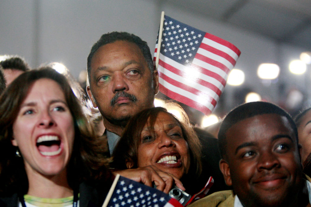 FILE PHOTO: Rev. Jesse Jackson watches Barack Obama during his election night rally in Chicago