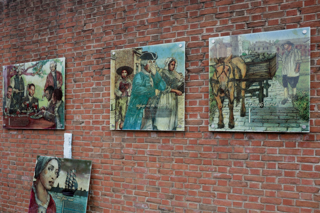 Workers from the National Park Service reinstall a slavery exhibit at a historic site in Philadelphia