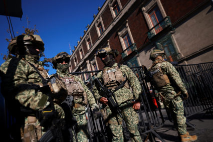 Members of the army patrol the perimeter of Palacio Nacional in Mexico