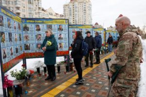 People visit a memorial dedicated to fallen Ukrainian defenders, in Kyiv