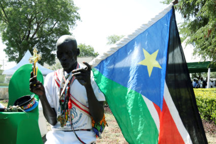 FILE PHOTO: A man holding a South Sudan's flag takes part in a national day of prayers for peace lead by South Sudan's Pre...