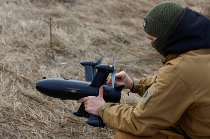 Employee checks P1-Sun interceptor drone before flying it at a training ground during an examination for military drone op...