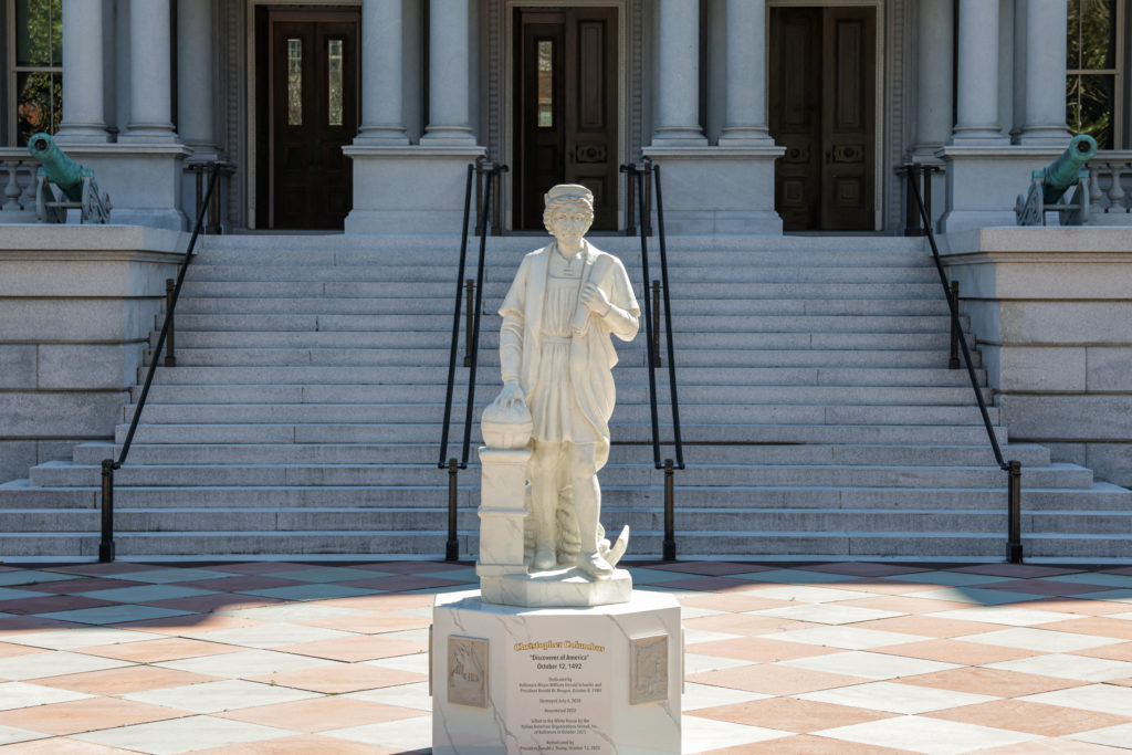 A statue of Christopher Columbus stands outside the Eisenhower Executive Office Building near the White House